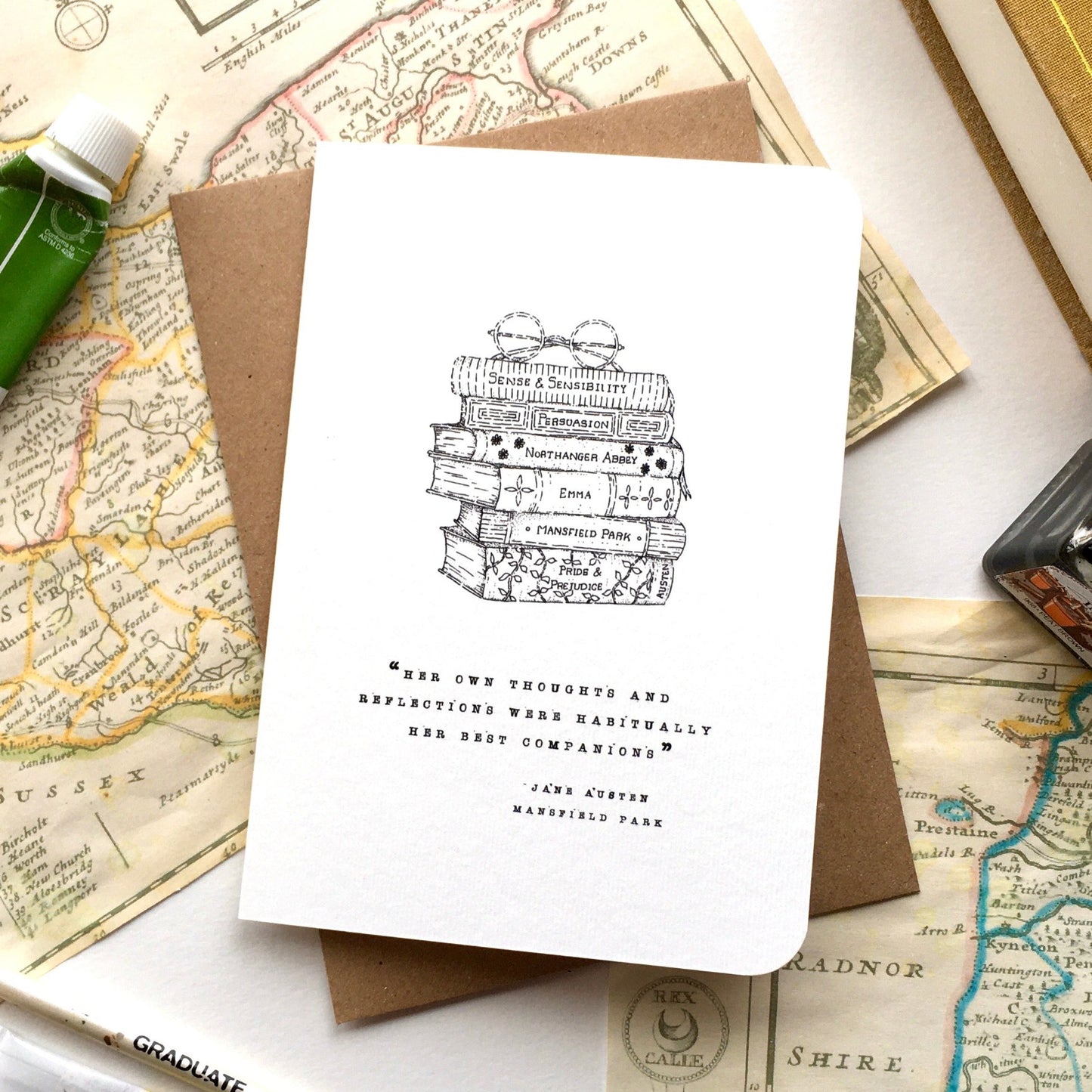 A stack of Jane Austen's Novels with some Spectacles —just the ticket for sending a Note to someone whose nose is always in a book! Perfect for a special Birthday or Thank you, or just to say hello!